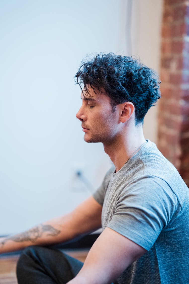 A person sitting quietly with eyes closed